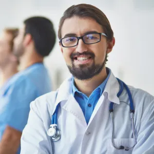 male clinician smiling