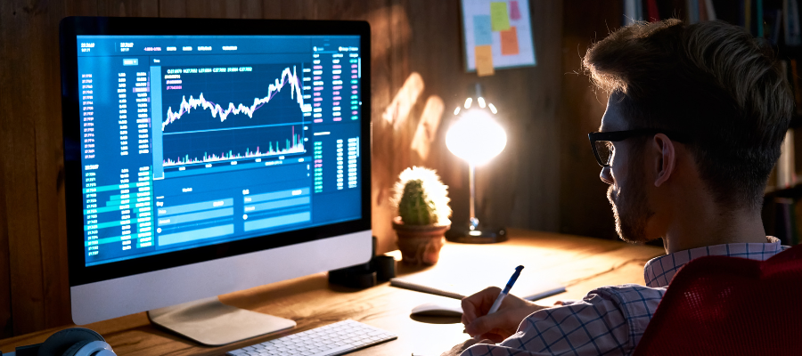 Photo of man reviewing statistics on computer